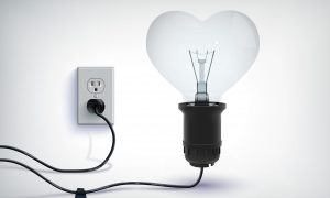 Realistic romantic concept of realistic wired light bulb in heart shape with plug in socket isolated vector illustration